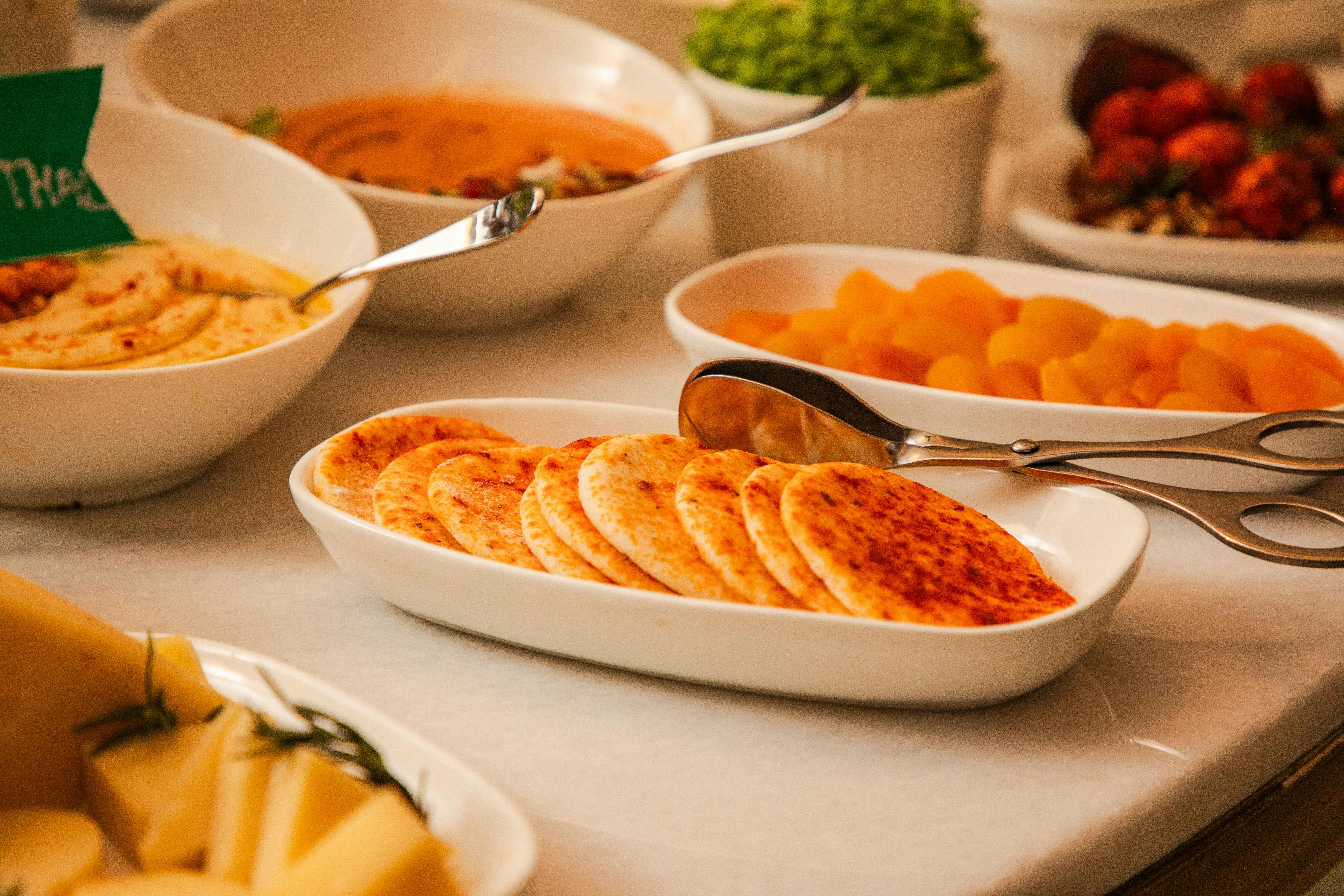 A variety of appetizing artisan dishes elegantly arranged on a table with a warm and inviting feel.